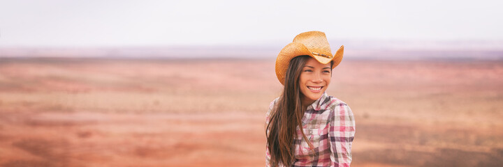 Cowgirl woman smiling happy on country farm landscape wearing cowboy hat. Banner of young...