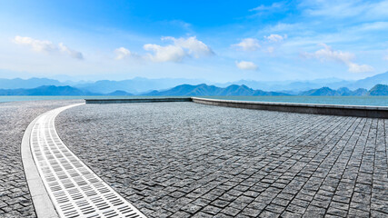 Empty square floor and mountain with lake landscape under the blue sky.