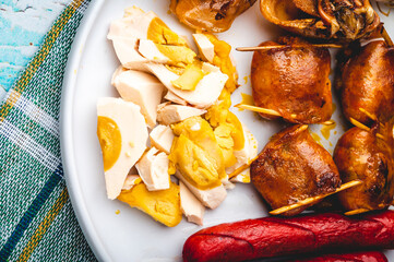 Pinoy Breakfast Platter- Salted Duck Egg (Itlog na Pula), Longganisa, Hotdogs, Dried Squid with cucumber on the side (side profile right)