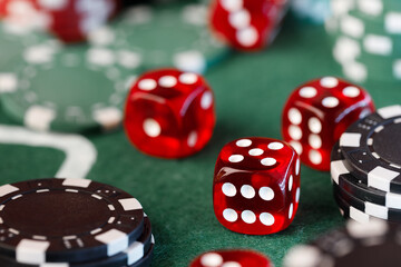 Poker chips and dice on green table