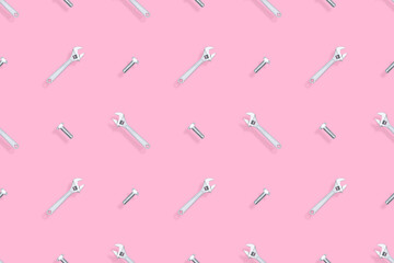 Adjustable metal wrench seamless pattern. Background from a metal wrench and a bolt. 