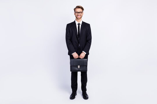 Full body photo of young business man happy positive smile hold bag wear suit isolated over grey color background