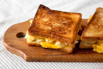 Homemade Grilled Macaroni and Cheese Sandwich on a rustic wooden board, low angle view. Close-up.