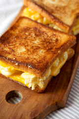 Homemade Grilled Macaroni and Cheese Sandwich on a rustic wooden board, side view. Close-up.