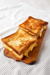 Homemade Grilled Macaroni and Cheese Sandwich on a rustic wooden board, low angle view. Copy space.