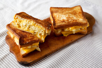 Homemade Grilled Macaroni and Cheese Sandwich on a rustic wooden board, low angle view.
