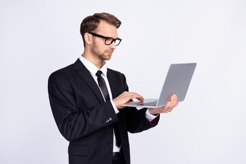 Profile side photo of young man focused look read browse laptop project report isolated over grey color background