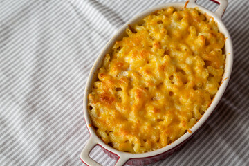 Homemade Macaroni and Cheese Pasta on cloth, low angle view. Copy space.