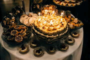 Sweet table with a beautiful cake in the center