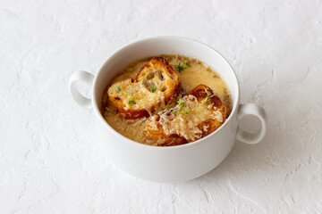 French onion soup with toasts and cheese. French cuisine. Vegetarian food.
