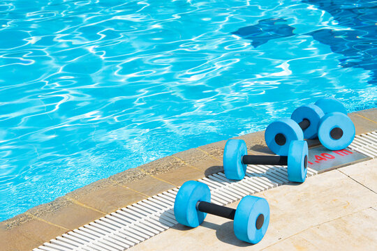dumbbells equipment for aqua aerobics sport near swimming pool