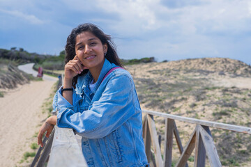 Fototapeta na wymiar Young Indian woman happy in beach 
