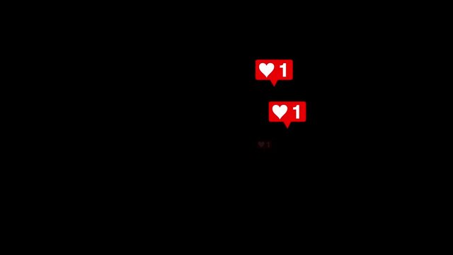 Red hearts and likes symbols flying up on black alpha channel 4k background. Social media and approving bubbles with numbers and hearts symbols on black background