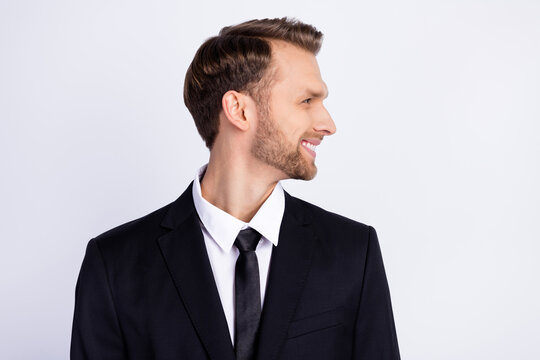 Profile side photo of young business man happy positive smile look empty space isolated over grey color background