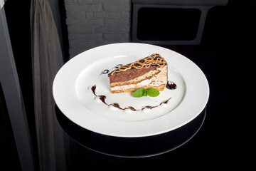 One slice of bird milk cake on a white plate