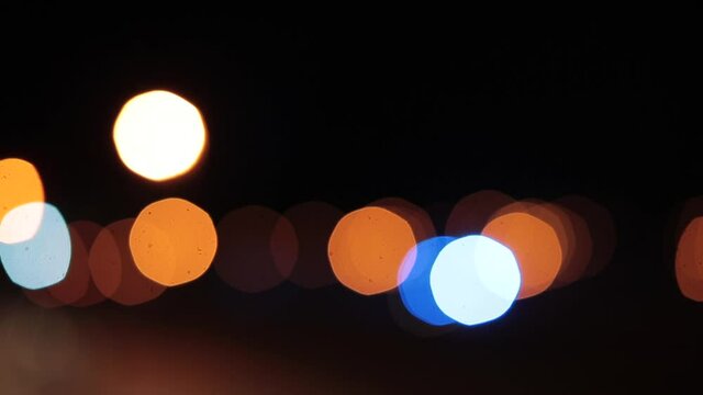 Ambulance flare motion in bokeh. Prompt response to the problem in the city. Assisting at night.