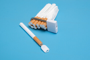 Quit smoking concept. Cigarettes squeezed into a lock on a blue background. Bad limiting habit.