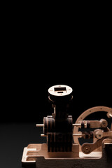 Model engine made of wood and plywood on a black background