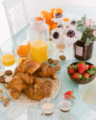 selective focus. Continental breakfast with croissants, orange juice and coffee or tea
