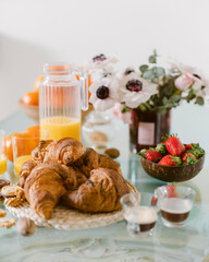 selective focus. Continental breakfast with croissants, orange juice and coffee or tea