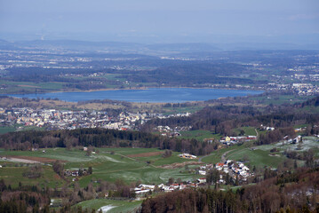 Fototapeta na wymiar Panoramic landscape with lake Pfäffikon in the background, seen from mountain Bachtel. Photo taken April 8th, 2021, Zurich, Switzerland.