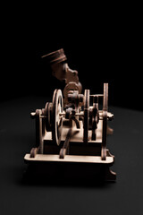 A wooden engine on a black background close-up