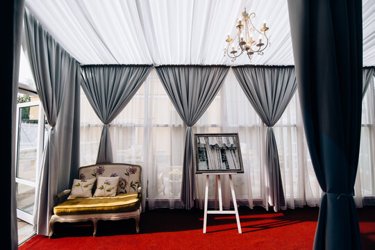 Interior with a sofa, curtains, and a malbert