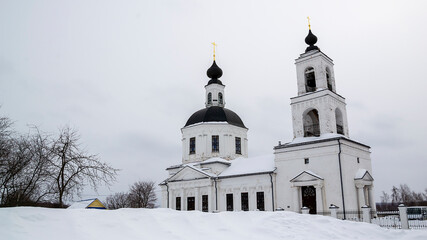 orthodox church made of white brick in winter