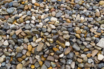 round and edgy gravel stones on the beach