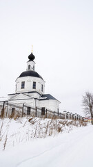 orthodox church made of white brick in winter