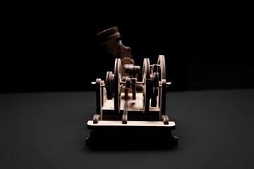 A wooden engine on a black background close-up