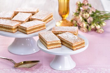 Homemade apple cake with pink roses in the background
