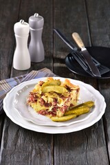 Baked ham and egg pasta, traditional Czech food called sunkofleky, with pickles