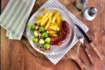 Grilled sausage with homemade chips and Brussels sprouts