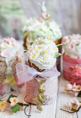 Easter composition with orthodox sweet breads or kulich decorated with white sugar icing and mastic flowers. Traditional Orthodox cake. Holiday concept.