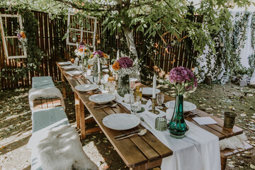 Wedding table setting with glasses, candles and flowers