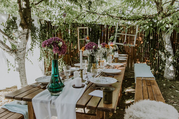 Wedding table setting with glasses, candles and flowers