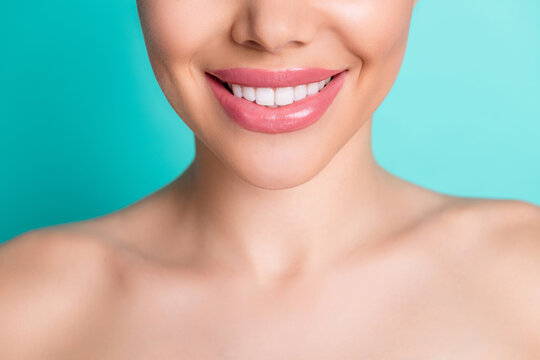 Cropped photo of young cheerful smiling lovely woman showing perfect white teeth isolated on teal color background