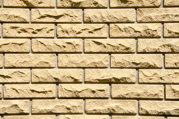 Close-up beige brick wall with copy space. Grunge brick wall background. Beige brick wall for...