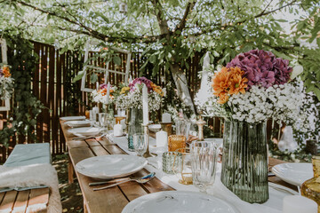 Wedding table setting with glasses, candles and flowers