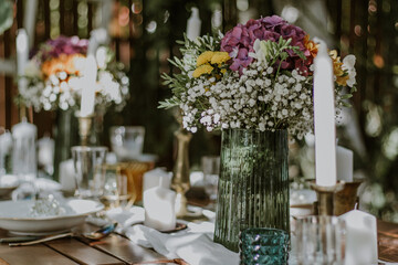 Wedding table setting with glasses, candles and flowers