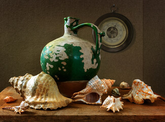 Still life with an old peeling jug, a barometer on the wall and seashells. Vintage.