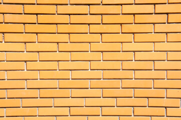 Close-up orange brick wall with copy space. Grunge brick wall background. Terracotta brick wall for texture. Decorative brick wall surface.