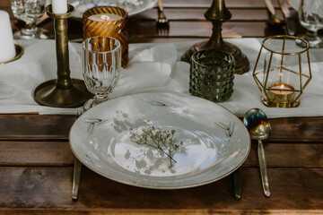 Wedding table setting with glasses, candles and flowers