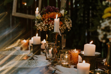 Wedding table setting with glasses, candles and flowers