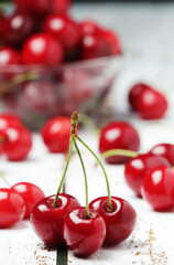 Ripe fresh cherry on a white rustic wooden table	