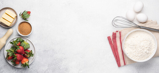 Baking strawberry pie white background. Flour, butter, eggs and kitchen utensils on white stone table. Empty space for menu or recipe. View from above