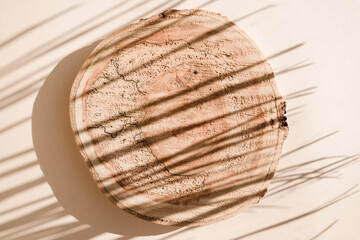 Wooden background with hursh palm leaves shadows. Minimal concept mock up background.