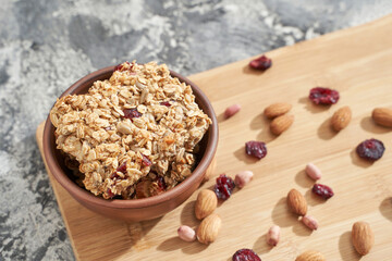 Healthy food. Oatmeal dessert. Almond, cranberry, peanut, honey. Cereal homemade snack at bowl. Crispy brown buscuit. Whole grain breakfast