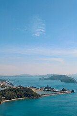 Naklejka na ściany i meble High point view for looking at the location of Sattahip Naval Base with clear sky and blue sea. Sea view and the island close to Sattahip Naval Base, Thailand.